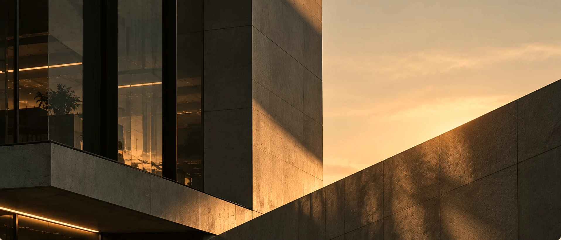 Stone and glass office facade at sunset
