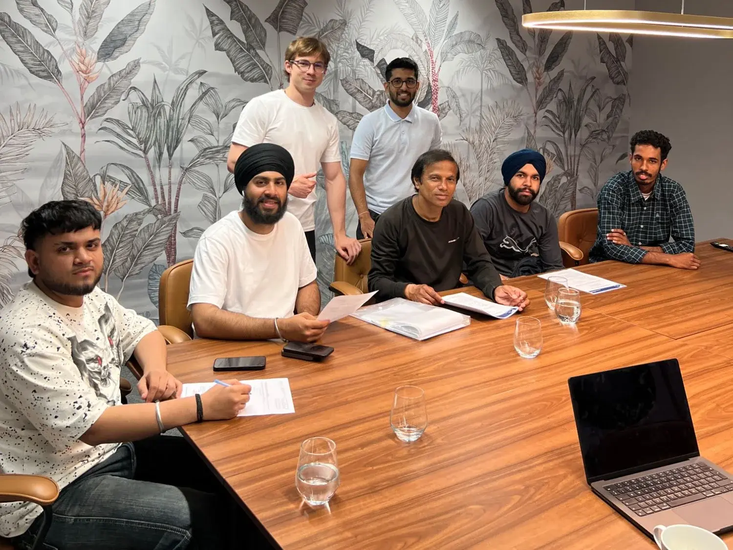 Our team with clients at a meeting table, going through documents
